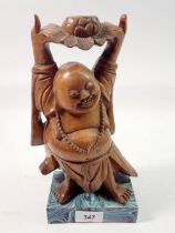 A Chinese carved wood Buddha figure with lotus flower, 27cm tall