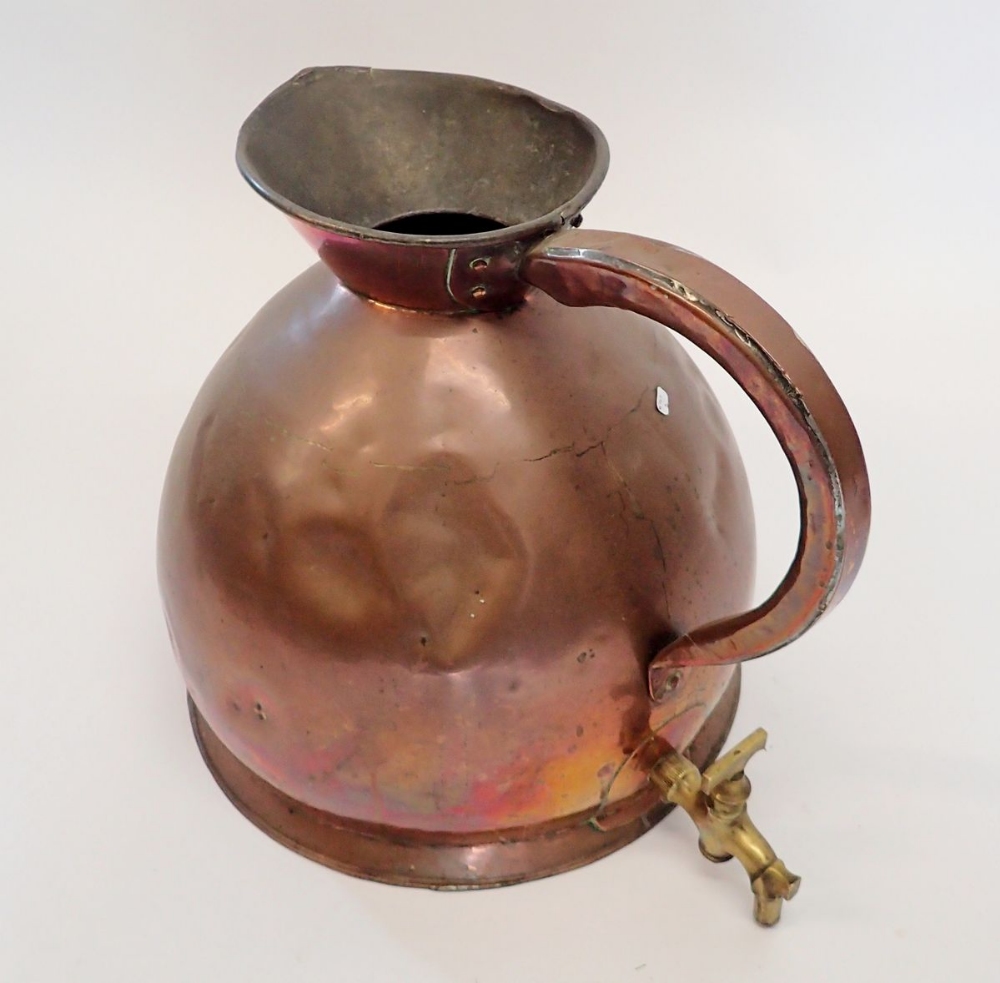 A large Victorian copper kitchen jug with brass tap fitted under handle, 38cm tall