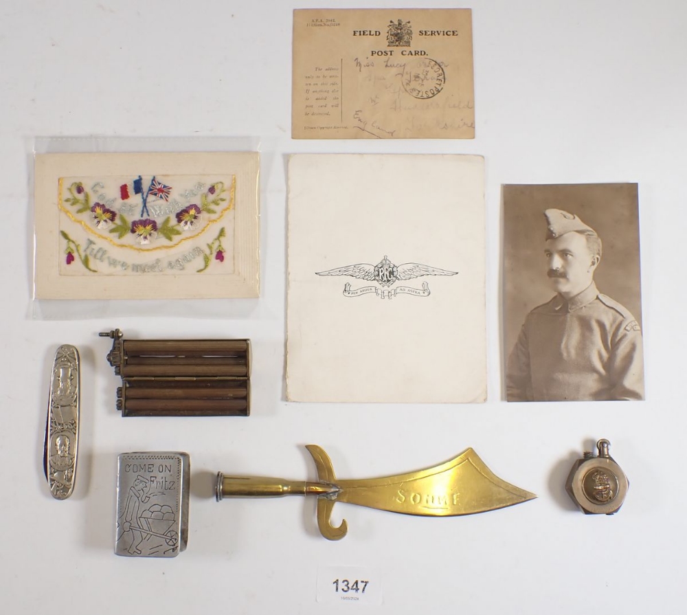 A brass WWI naval lighter and various other military collectables including postcard, trench art