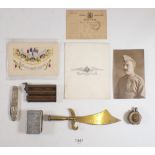 A brass WWI naval lighter and various other military collectables including postcard, trench art