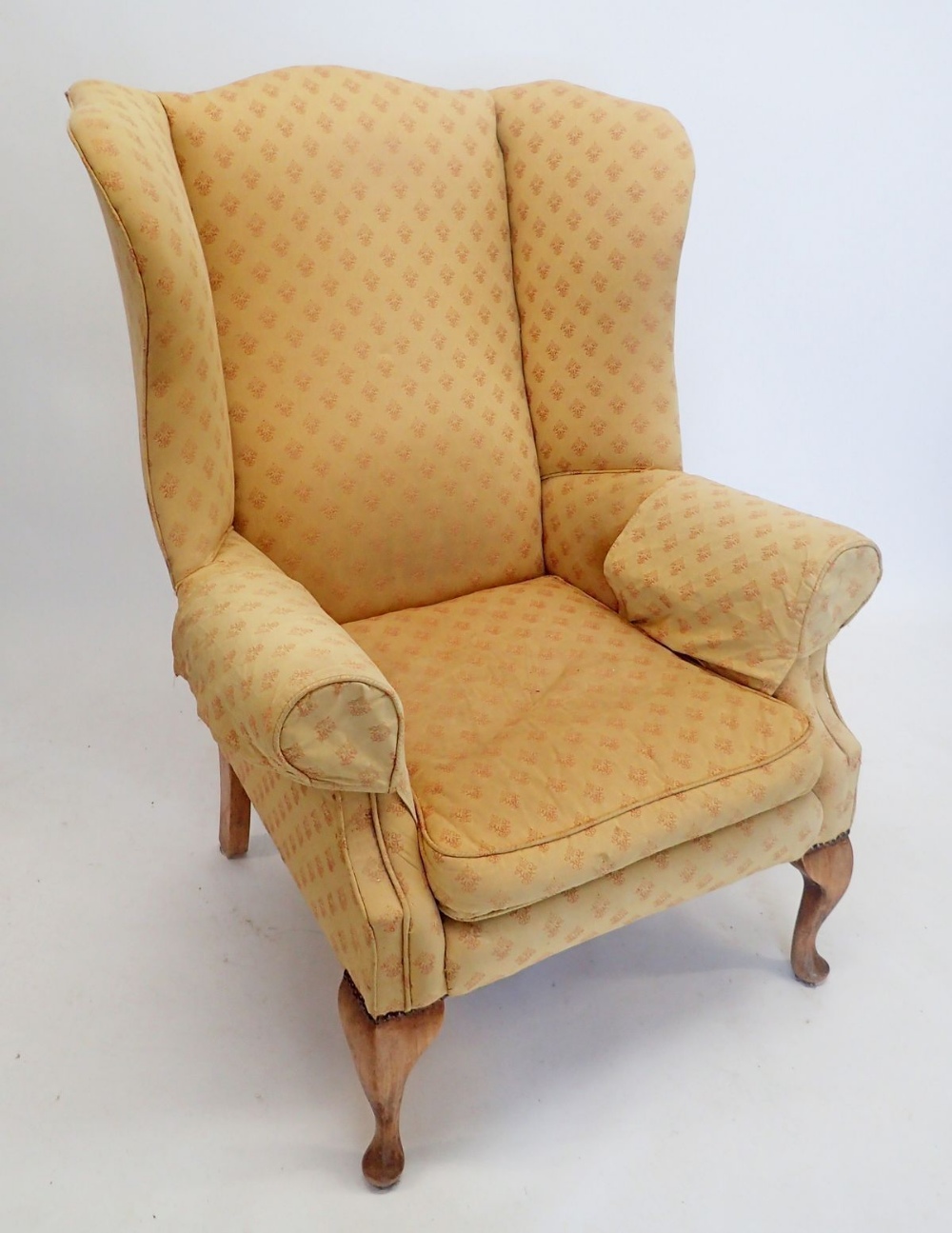 A wing armchair on cabriole supports
