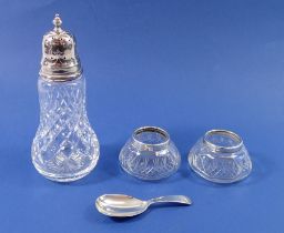A pair of silver rimmed and cut glass salts, Chester 1925, a silver caddy spoon, London 1973, 19g