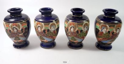 A Japanese set of four late Satsuma vases painted seated figures, 19cm