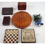 A Victorian boxed travellers set of simulated ivory draughts, a leather playing card box, games