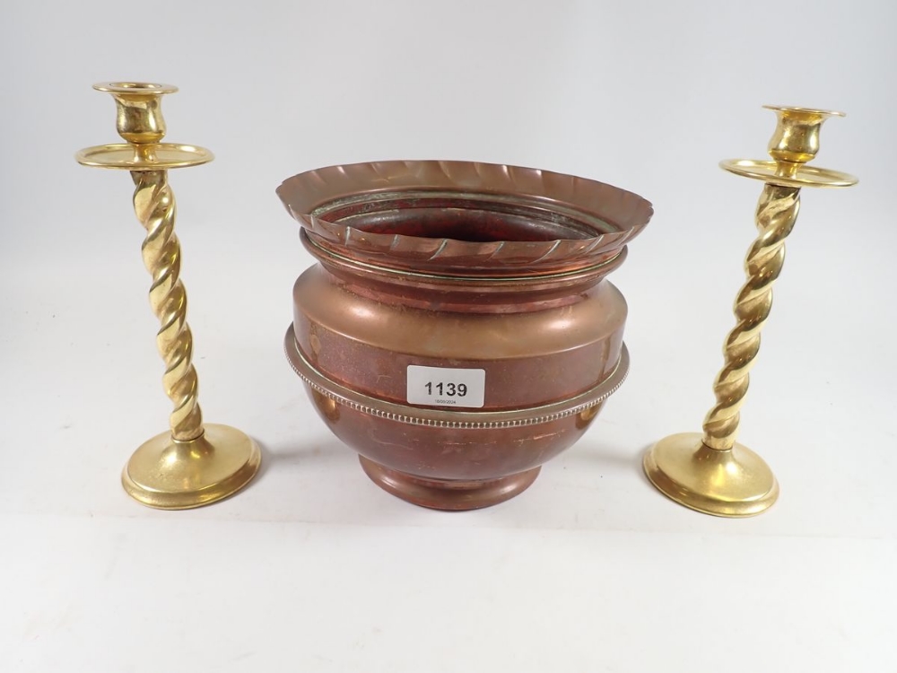 A pair of brass wrythen twist candlesticks, 25cm and copper jardiniere