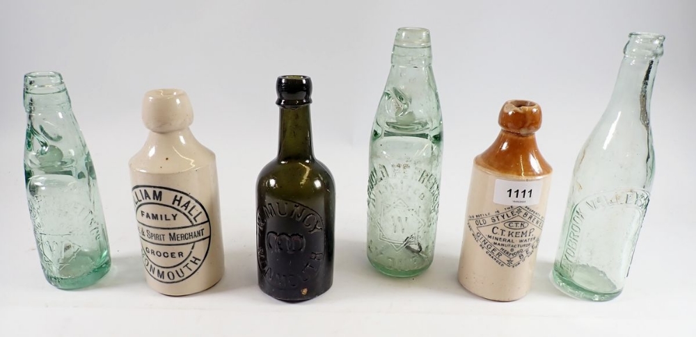 A group of stoneware and glass bottles including William Hall, Family Grocer, Monmouth and W