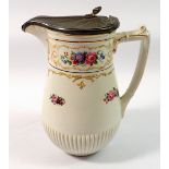 A Winton floral painted jug with pewter lid, 18cm tall