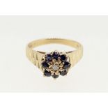 A 9 carat gold sapphire and chip diamond ring on textured band, size M, 2.4g