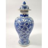 A Chinese 18th century blue and white baluster vase and cover with all over floral decoration, 28cm