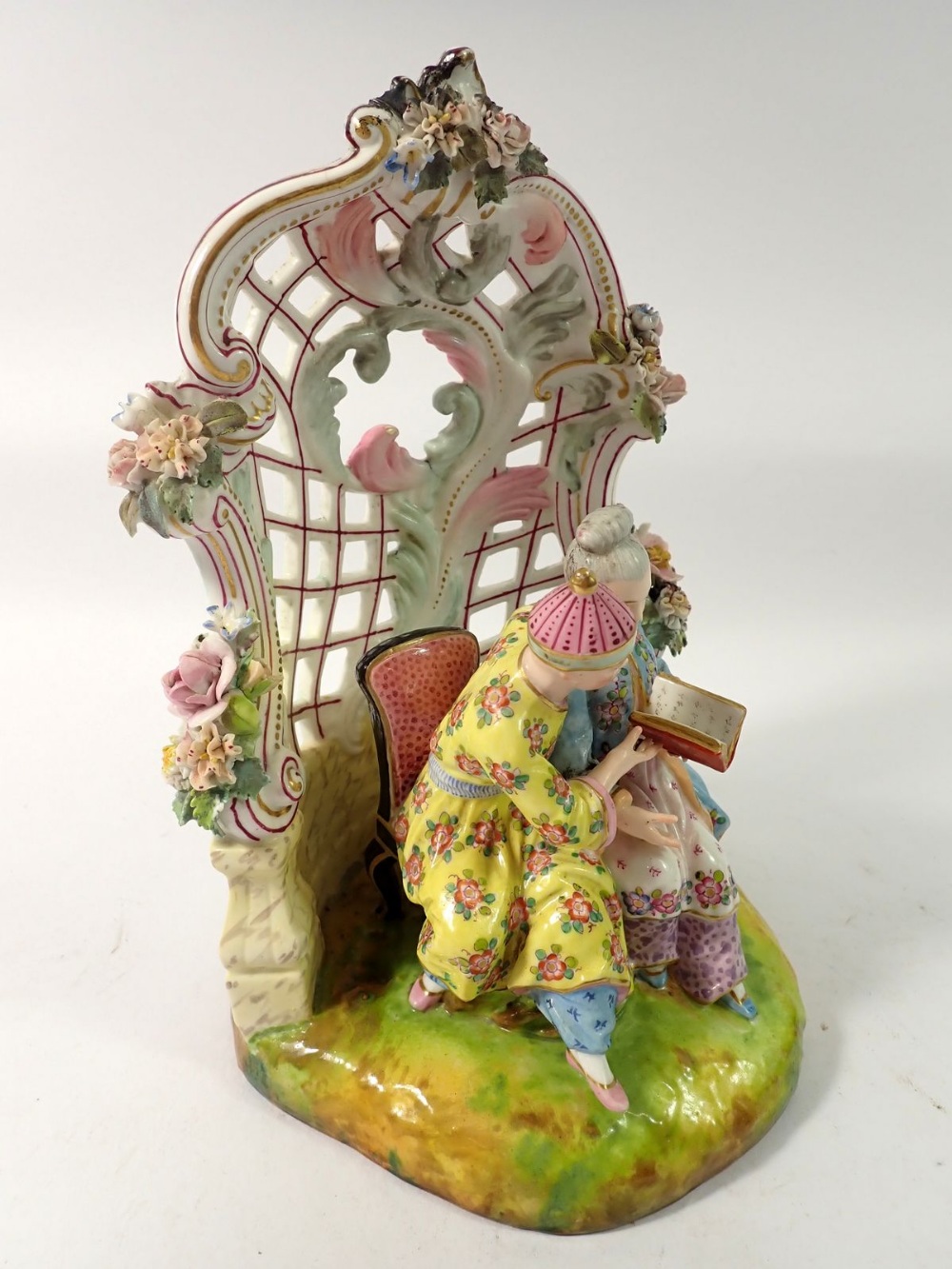 A 19th century Meissen style group of Chinese couple seated reading in floral and scrollwork - Image 3 of 6