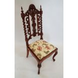 A Victorian small chair with ornately carved back