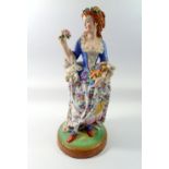 A 19th century French porcelain large figure of a woman with flowers, 44cm tall