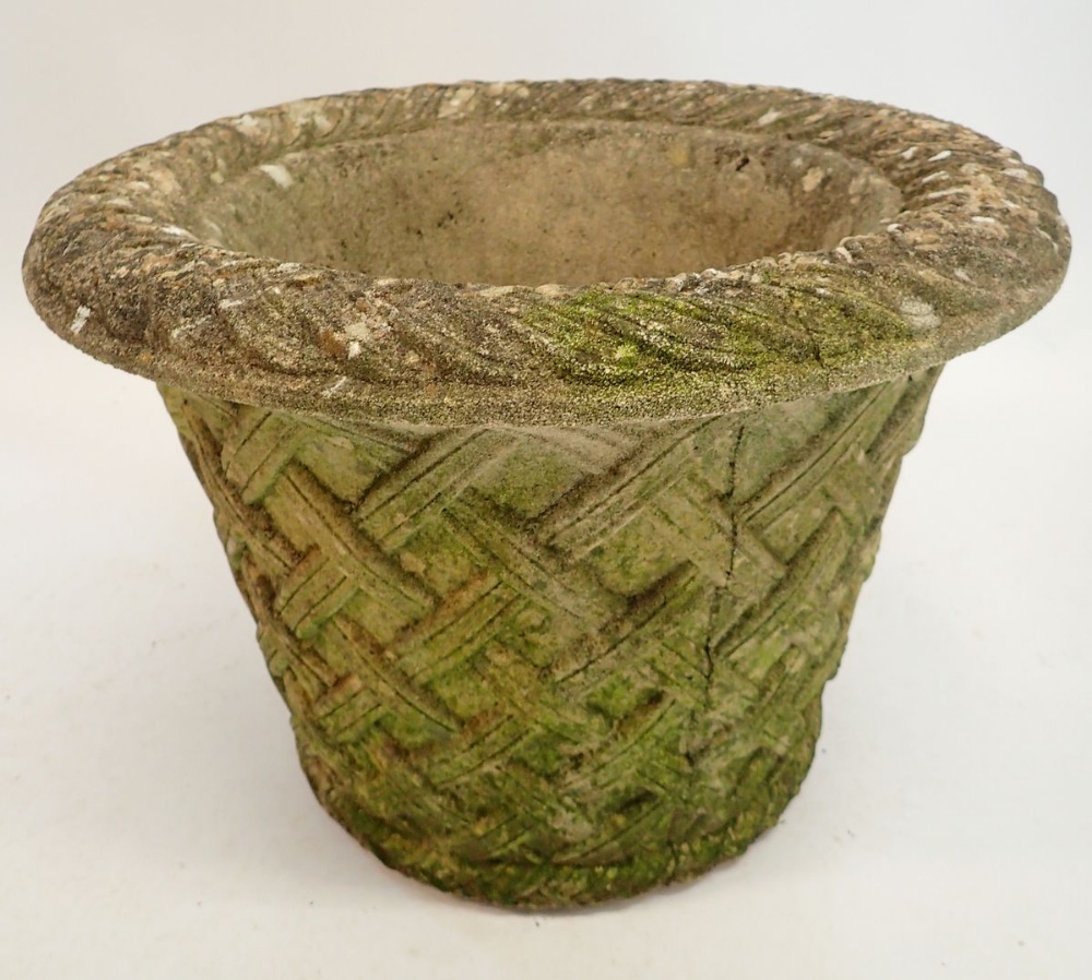A reconstituted stone garden urn with basket weave decoration 33cm tall