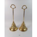 A pair of Georgian brass door stops or porters of bell form