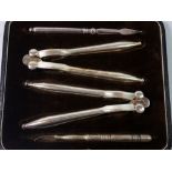 A set of silver plated nut crackers and picks, boxed
