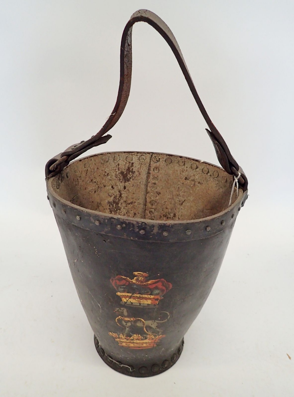 An 18th century leather fire bucket painted crowned dog heraldic crest, 31cm tall