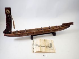 A carved Maori War canoe from New Zealand, 64cm long
