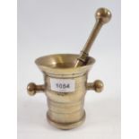 An antique brass pestle and mortar, 11cm tall