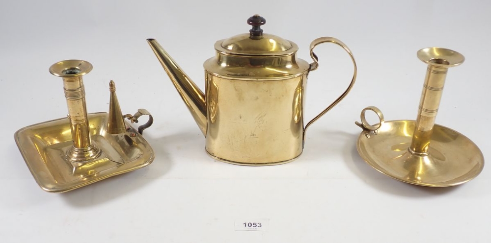 Two brass chamber sticks and a brass teapot