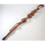 A carved wood Nyami Nyami walking stick, 90cm