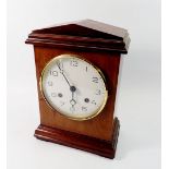 A 19th century mahogany mantel clock with arch top and enamel dial with pendulum and key, 31cm tall