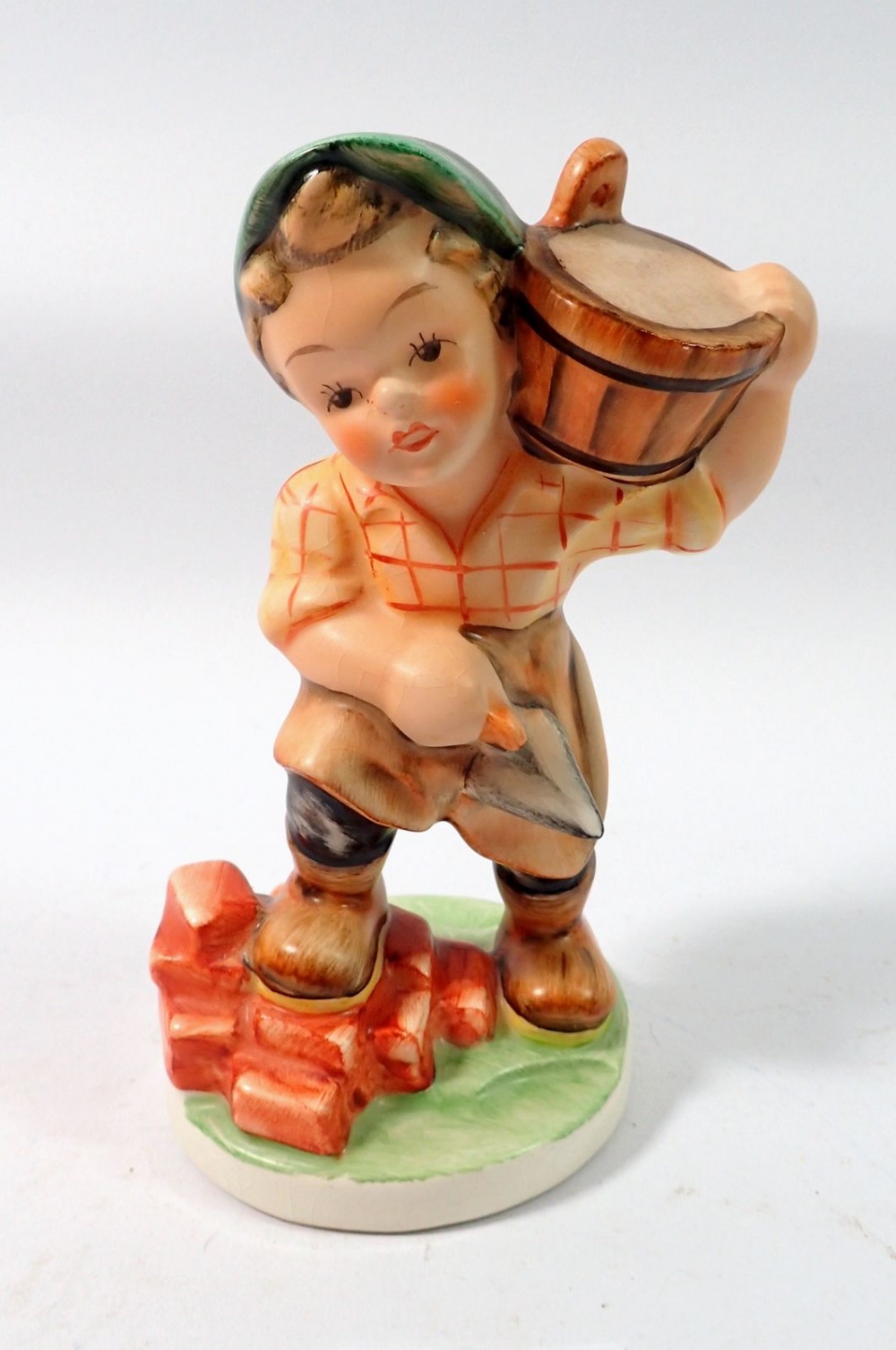 A Friedel figure of a child builder, 15cm tall