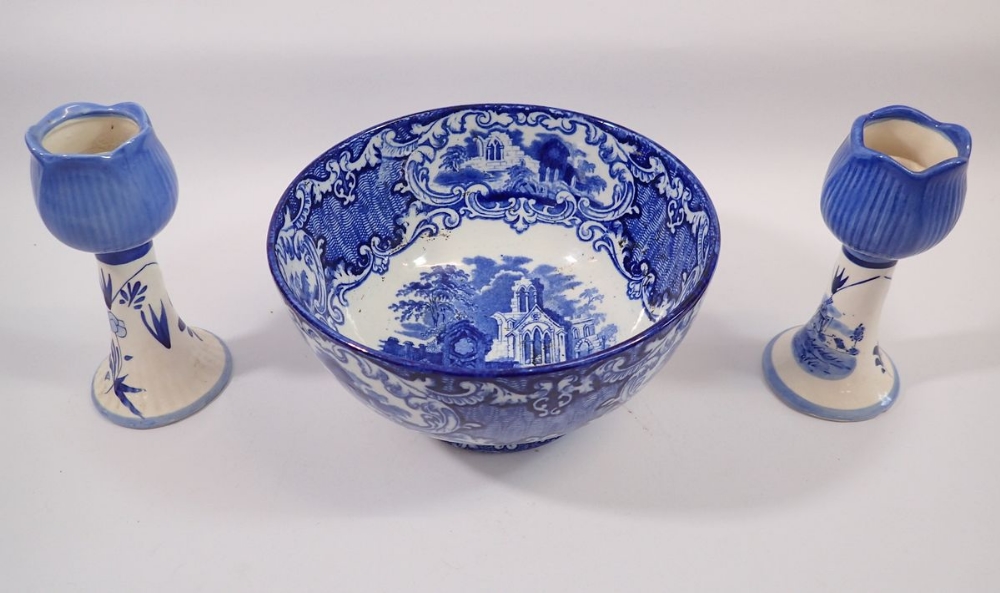 An Abbey blue and white fruit bowl and two Delft tulip form candlesticks, 16cm tall