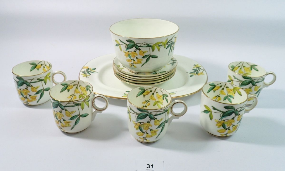 A Victorian part tea service decorated laburnum comprising 5 cups and saucers, sugar bowl and oval