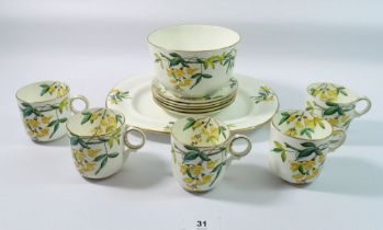 A Victorian part tea service decorated laburnum comprising 5 cups and saucers, sugar bowl and oval