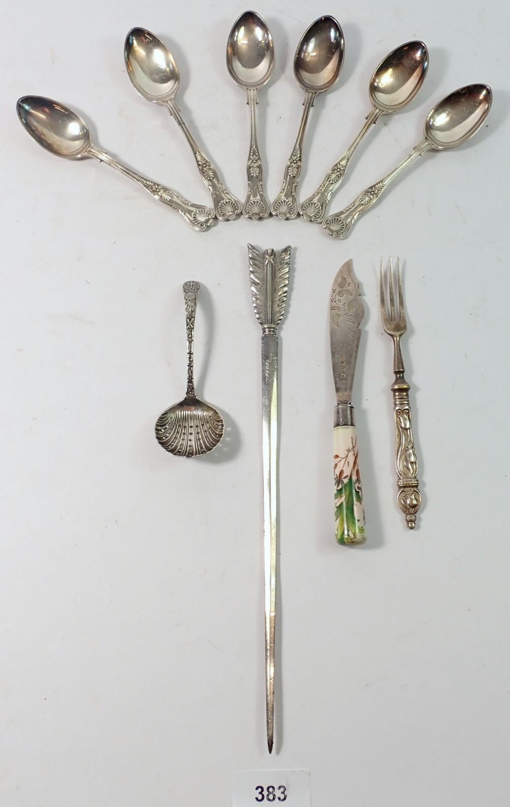 A silver plated arrow form paperknife and various silver plated cutlery
