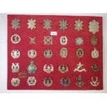 A framed display of thirty one Scottish cap badges