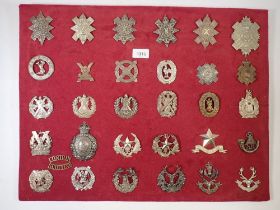 A framed display of thirty one Scottish cap badges