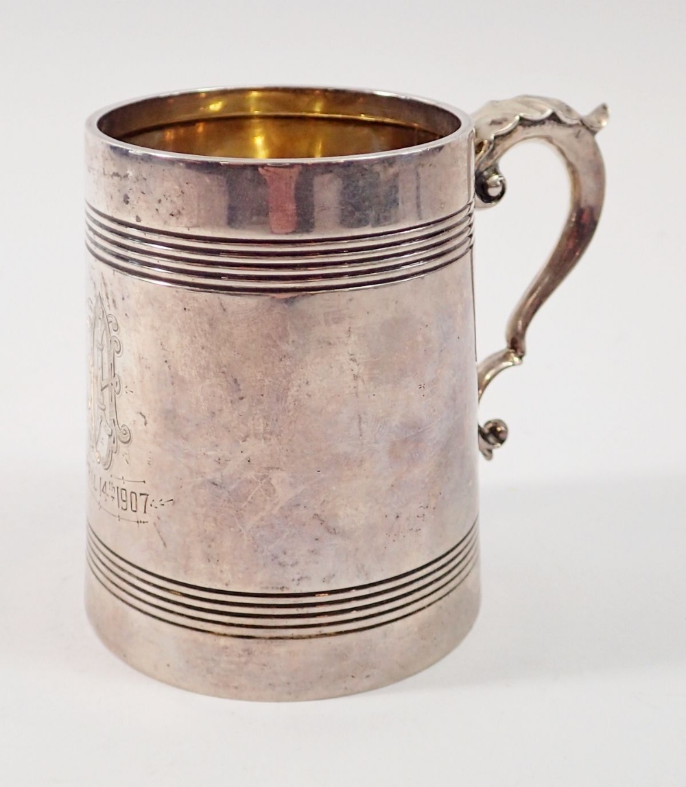 An Edwardian silver reeded small tankard with scroll handled, engraved monogram and dated 1907,