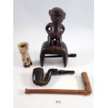 A group of four tribal items comprising figurative heddle weaving pulley, a Shona Nguni carved pipe,