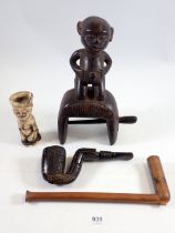 A group of four tribal items comprising figurative heddle weaving pulley, a Shona Nguni carved pipe,