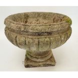 A reconstituted stone fluted urn 37cm tall