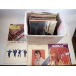 A box of records including The Beatles, Elvis, Dolly Parton and a wide selection of other genres