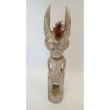 A large carved and painted Voodoo tribal figure with long ears, 99cm tall