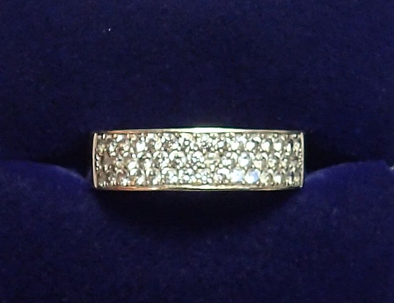 An 18 carat gold modern wide band ring set three rows of small diamonds, size H-I, 4.5g