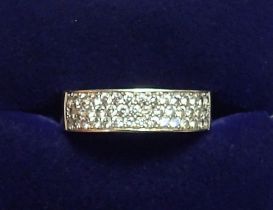 An 18 carat gold modern wide band ring set three rows of small diamonds, size H-I, 4.5g