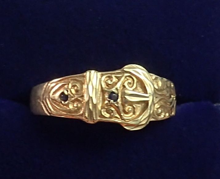 A 9 carat gold Victorian style buckle ring set two blue stones, size U, 2.6g