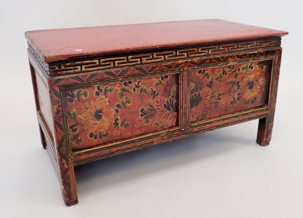 A small Chinese red painted wooden chest with floral decoration, secret door to reverse, 75 x 38 x