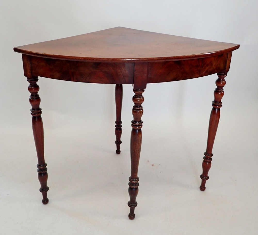 A Victorian mahogany corner table on turned supports, 90cm wide