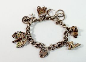 A silver charm bracelet with silver and white metal charms, 48g
