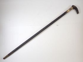 An antique ebonised sword stick with bone inlay