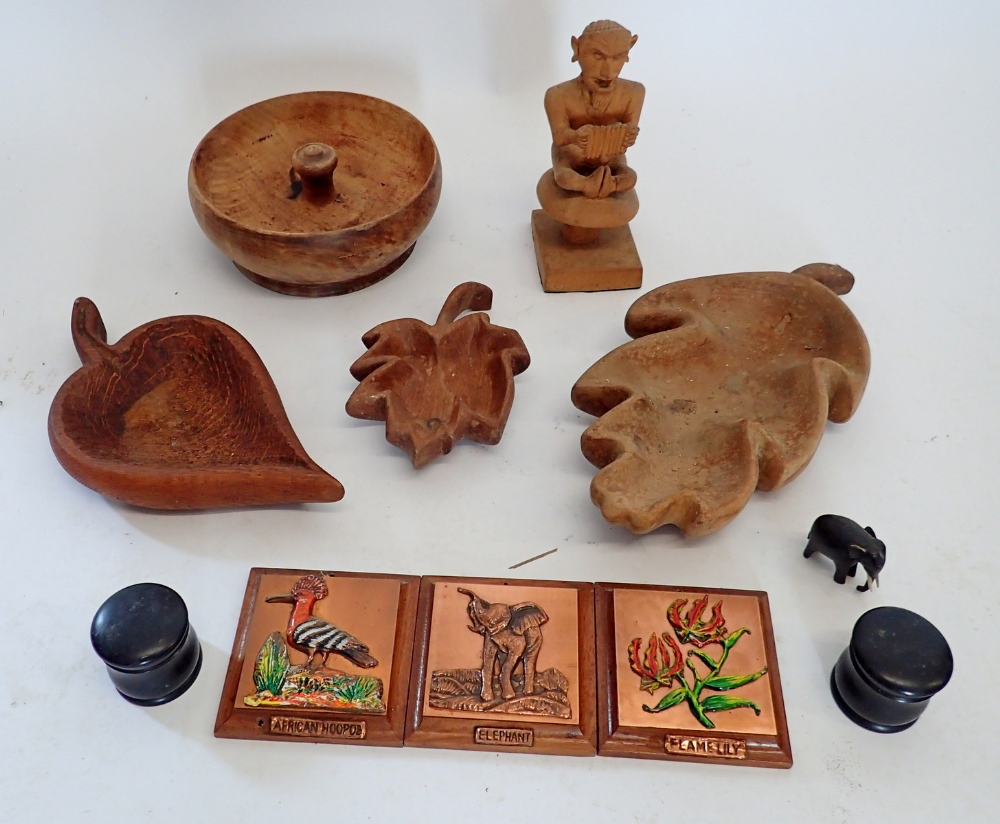 A group of treen including leaf shaped bowls, ebonised pots etc.