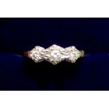 A 9 carat gold illusion set three stone diamond ring, size L to M, 2.2g