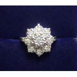 An 18 carat white gold star form ring illusion set diamonds, size H, 3.6g