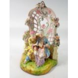 A 19th century Meissen style group of Chinese couple seated reading in floral and scrollwork