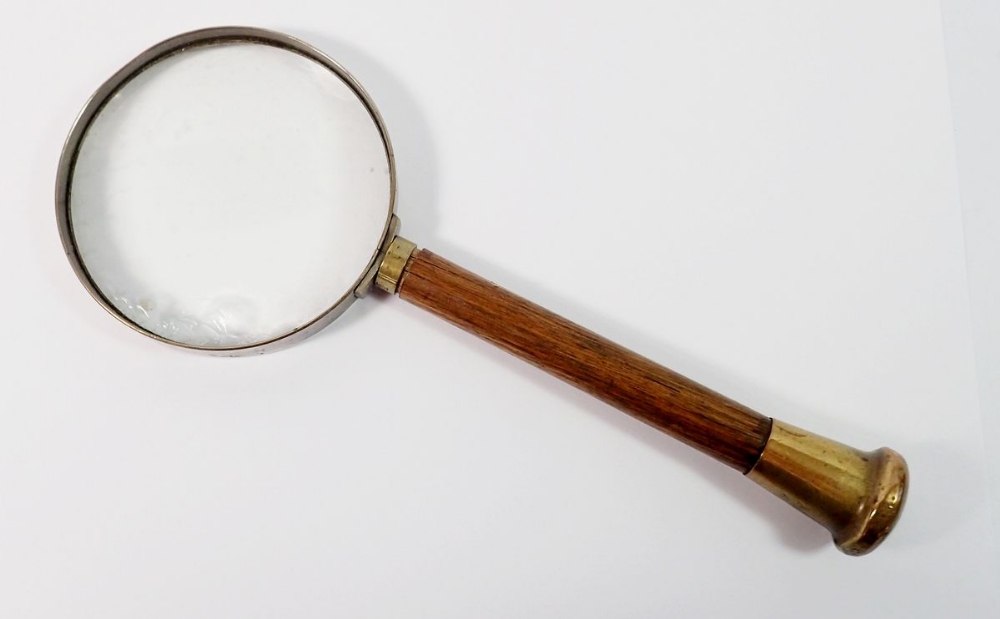 An old magnifying glass with wooden handle